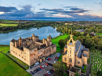 Sunset over Linlithgow Palace from a drone, Linlithgow Loch, West Lothian, Scotland, United Kingdom