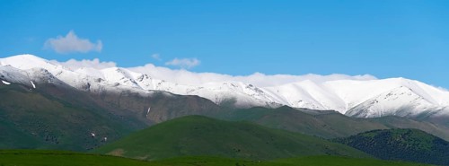 Snow-covered mountain range under a clear blue sky, landscape near Saratovka, Lesser Caucasus,