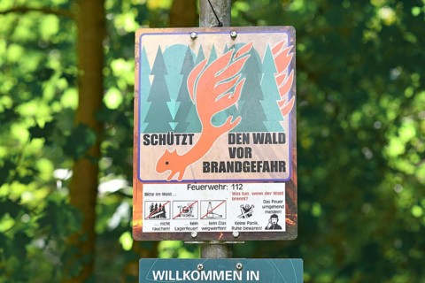 Mannheim, Germany - July 31st 2025: German forest fire hazard warning sign in dry woodland forest