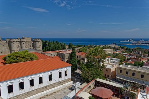 View of a historic town with castle, red roofs and sea in the background, Medieval Town of Rhodes,