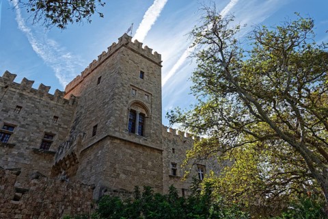 Medieval castle with stone towers under a clear sky and surrounded by trees, d'Amboise Gate,
