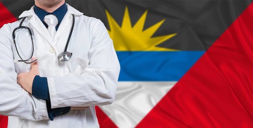Male doctor with stethoscope on Antigua and Barbuda flag. Doctor holding stethoscope on Antigua and