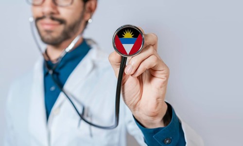 Doctor holding stethoscope with Antigua and Barbuda flag. Antigua and Barbuda health and care