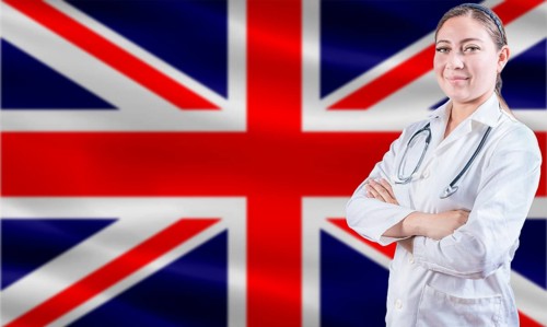 Female doctor on United Kingdom flag. Doctor with crossed arms on United Kingdom flag. United
