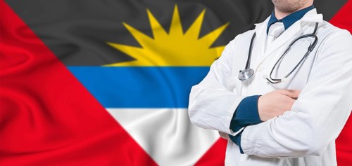 Antigua and Barbuda healthcare concept. Male doctor on Antigua and Barbuda flag. Doctor with