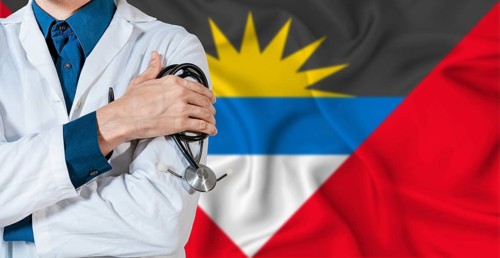 Doctor with stethoscope on Antigua and Barbuda flag. Doctor holding stethoscope on Antiguan and
