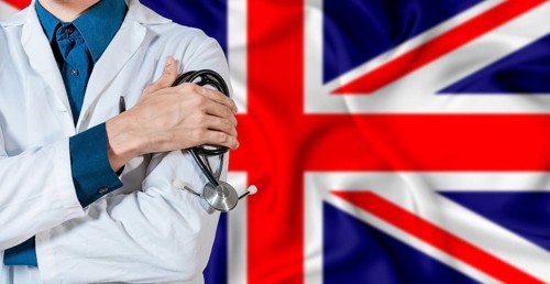 Doctor with stethoscope on United Kingdom flag. Doctor holding stethoscope on British flag