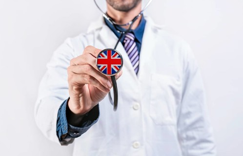 United Kingdom healthcare system, doctor holding stethoscope. United Kingdom health and medical