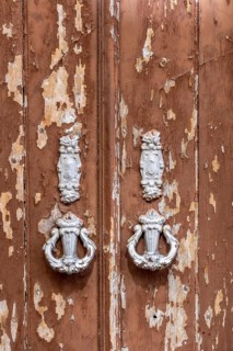 The old town centre of Tavira, typical door knockers found on many wooden doors in the town,