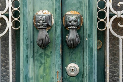 The old town centre of Tavira, typical door knockers found on many wooden doors in the town,