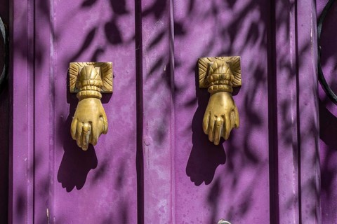 The old town centre of Tavira, typical door knockers found on many wooden doors in the town,