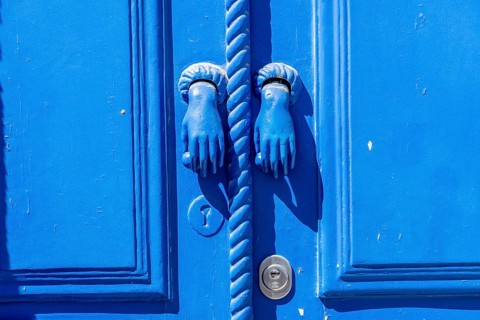 The old town centre of Tavira, typical door knockers found on many wooden doors in the town,