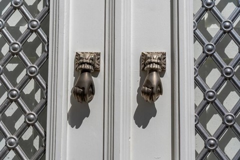 The old town centre of Tavira, typical door knockers found on many wooden doors in the town,