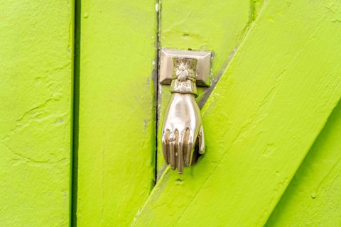 The old town centre of Tavira, typical door knockers found on many wooden doors in the town,