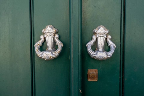 The old town centre of Tavira, typical door knockers found on many wooden doors in the town,