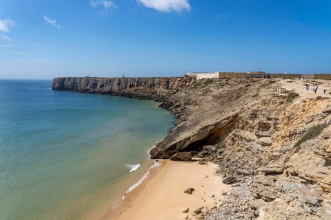 Rocky coast, cliffs in the south-west of the Algarve, near Sagres, old fortress Fortaleza de