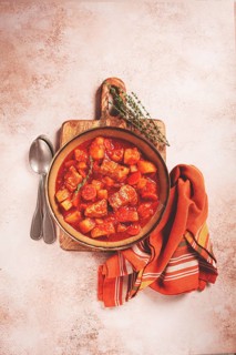 Meat goulash with potatoes and carrots, sweet peppers, in a saucepan, top view, traditional