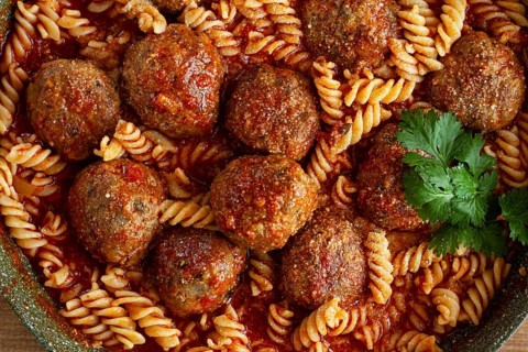 Minced meat meatballs, in tomato sauce, with fusilli pasta, in a cast-iron pan, homemade, no people