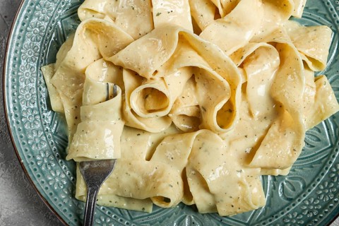 Pasta papardelle in creamy garlic sauce, traditional Italian cuisine, pasta carbonara, homemade, no