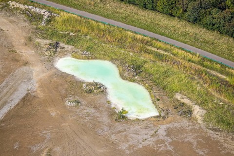 Aerial view, greenish shimmering pond at the landfill Wehofen, Averbruch, Dinslaken, Ruhr area,
