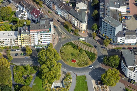 Aerial view, green roundabout and flower bed at D'Agen square and tram line, Dinslaken, Ruhr area,