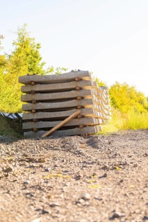 Stacked concrete sleepers under bright sunlight, Hermann Hessebahn construction site, Calw, Germany