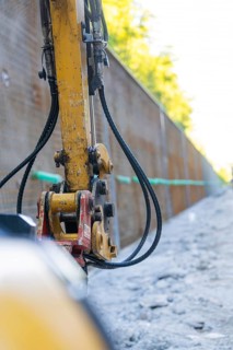 Close-up of a construction machine with hoses on a construction wall, Hermann Hessebahn
