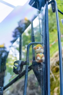 Toy figure with helmet behind a glass pane with nature in the background, Hermann Hessebahn