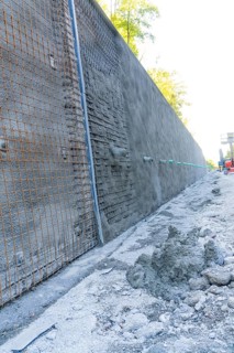 Construction site with a long concrete wall reinforced by wire mesh, Hermann Hessebahn construction