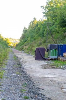 Gravel path with cover and containers along an overgrown embankment, Hermann Hessebahn construction