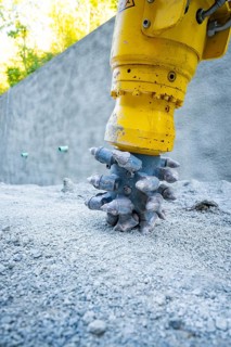Construction machine drilling into concrete on a building site, Hermann Hessebahn building site,