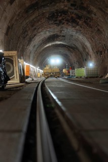 Rail construction in the tunnel with machines and equipment placed on the sides, construction of