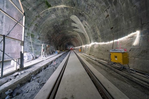 A tunnel still under construction with rails and artificial lighting, construction of the Hermann