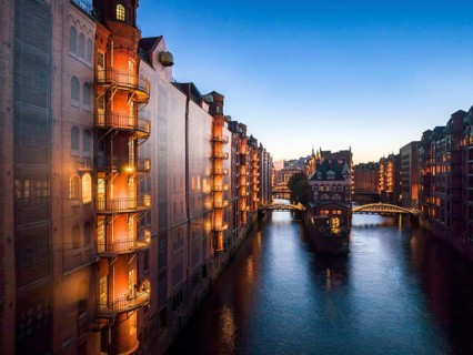 Evening view of the Hamburg warehouse district with a view of the moated castle from