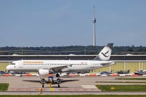 Stuttgart Airport with television tower and aeroplane. Aircraft registration number: TC-FBV,
