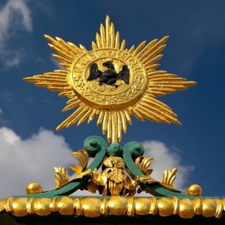 Golden star with black eagle and the Latin inscription suum cuique, to each his own, detail on the