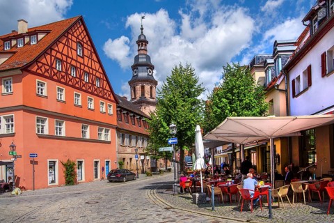 Half-timbered house with street café and hospital church in the old town, beer town Kulmbach,