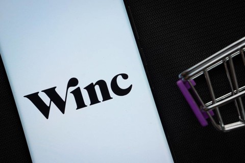 Dhaka, Bangladesh- 03 July 2025: A smartphone displaying the Winc logo next to a miniature shopping