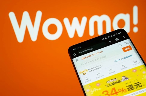 Dhaka, Bangladesh- 03 July 2025: Smartphone displaying wowma web interface against wowma logo
