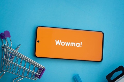 Dhaka, Bangladesh- 03 July 2025: Smartphone displaying wowma logo with shopping cart on a blue
