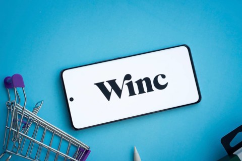 Dhaka, Bangladesh- 03 July 2025: Smartphone displaying Winc logo with shopping cart on a blue