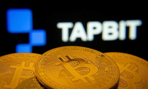 Dhaka, Bangladesh- 20 Sep 2025: Close-up of Bitcoin coins with thex Tapbit logo visible on a screen
