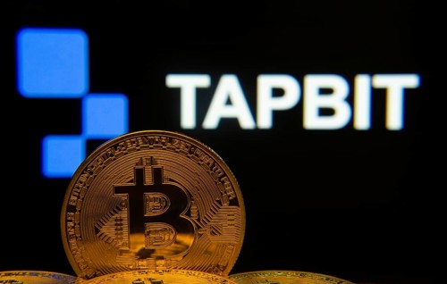 Dhaka, Bangladesh- 20 Sep 2025: Close-up of Bitcoin coins with thex Tapbit logo visible on a screen