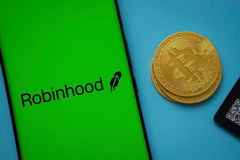 Dhaka, Bangladesh- 26 Aug 2025: Robinhood logo on smartphone screen near Bitcoin coin and QR code