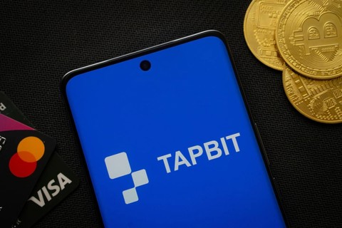 Dhaka, Bangladesh- 20 Sep 2025: Smartphone displaying Tapbit logo surrounded by Bitcoin coins and