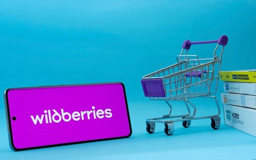 Dhaka, Bangladesh- 03 July 2025: Smartphone with Wildberries logo next to a small shopping cart and