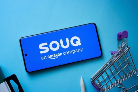 Dhaka, Bangladesh- 03 July 2025: Smartphone displaying Souq logo with shopping cart on a blue