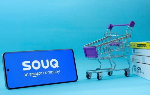 Dhaka, Bangladesh- 03 July 2025: Smartphone with Souq logo next to a small shopping cart and boxes