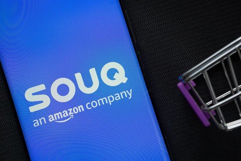 Dhaka, Bangladesh- 03 July 2025: A smartphone displaying the Souq logo next to a miniature shopping