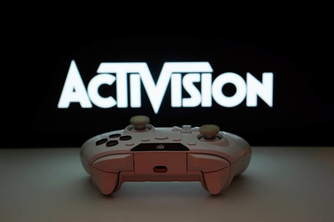 Dhaka, Bangladesh- 23 Sep 2025: A close-up of a white gamepad with the Activision seen on screen in